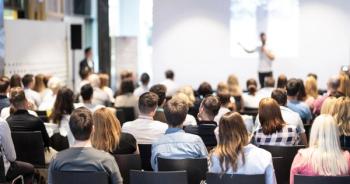 Conference attendees watching a speaker | Image credit: kasto - stock.adobe.com
