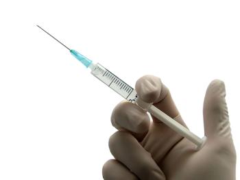 Health care professional holding an injection -- Image credit: Zsolt Bota Finna | stock.adobe.com