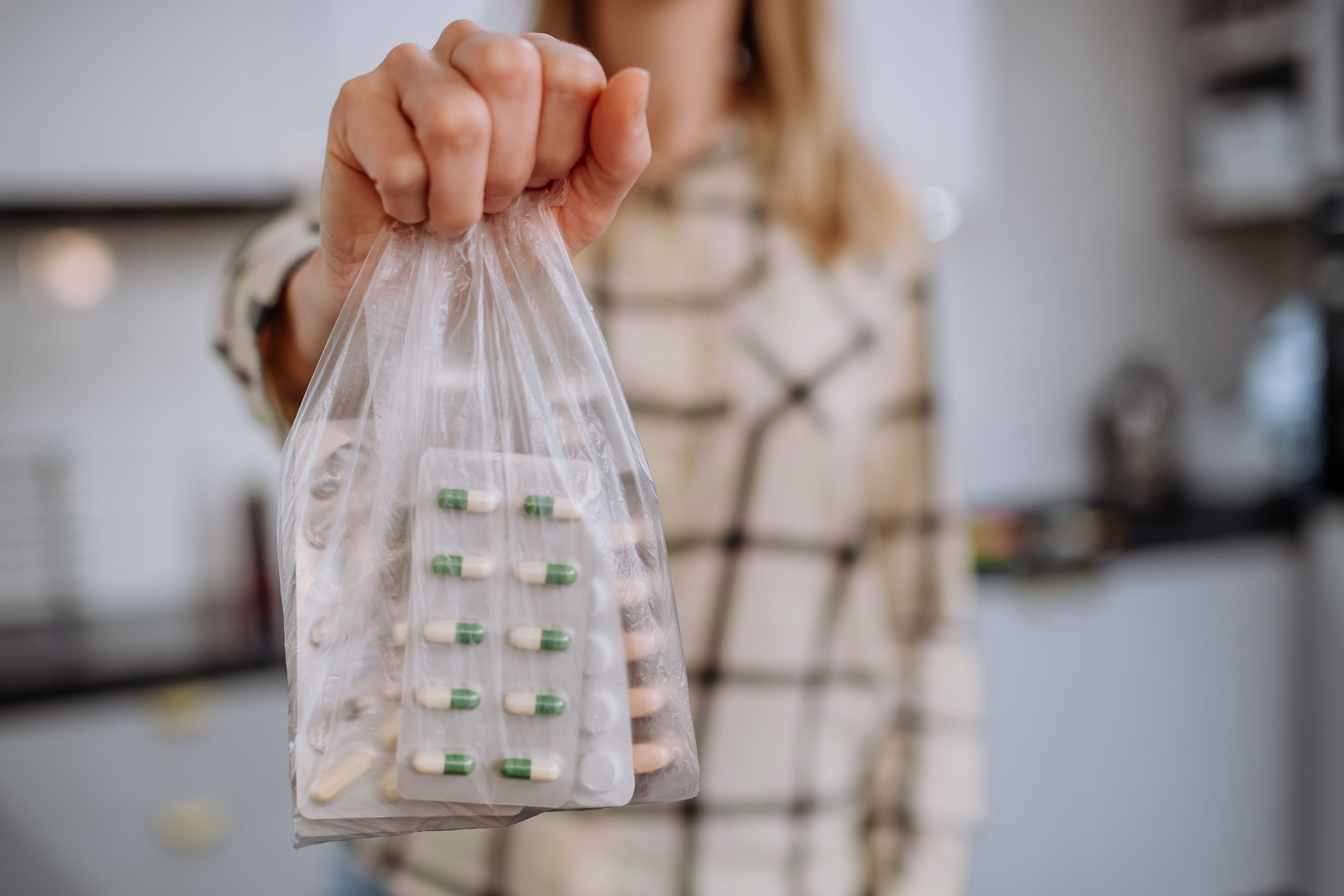 Woman disposing of medication -- Image credit: Halfpoint | stock.adobe.com