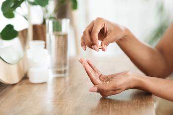 Woman with supplements in her hand.