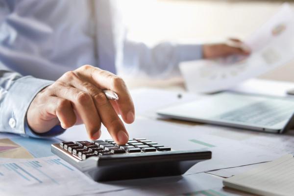 accountant working on desk using calculator for calculate finance report in office - Image credit: lovelyday12 | stock.adobe.com