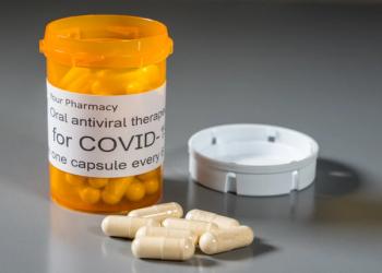 Prescription bottle and capsules illustrating trials of oral antiviral treatment for SARS-CoV-2 or Covid-19 virus - Image credit: steheap | stock.adobe.com
