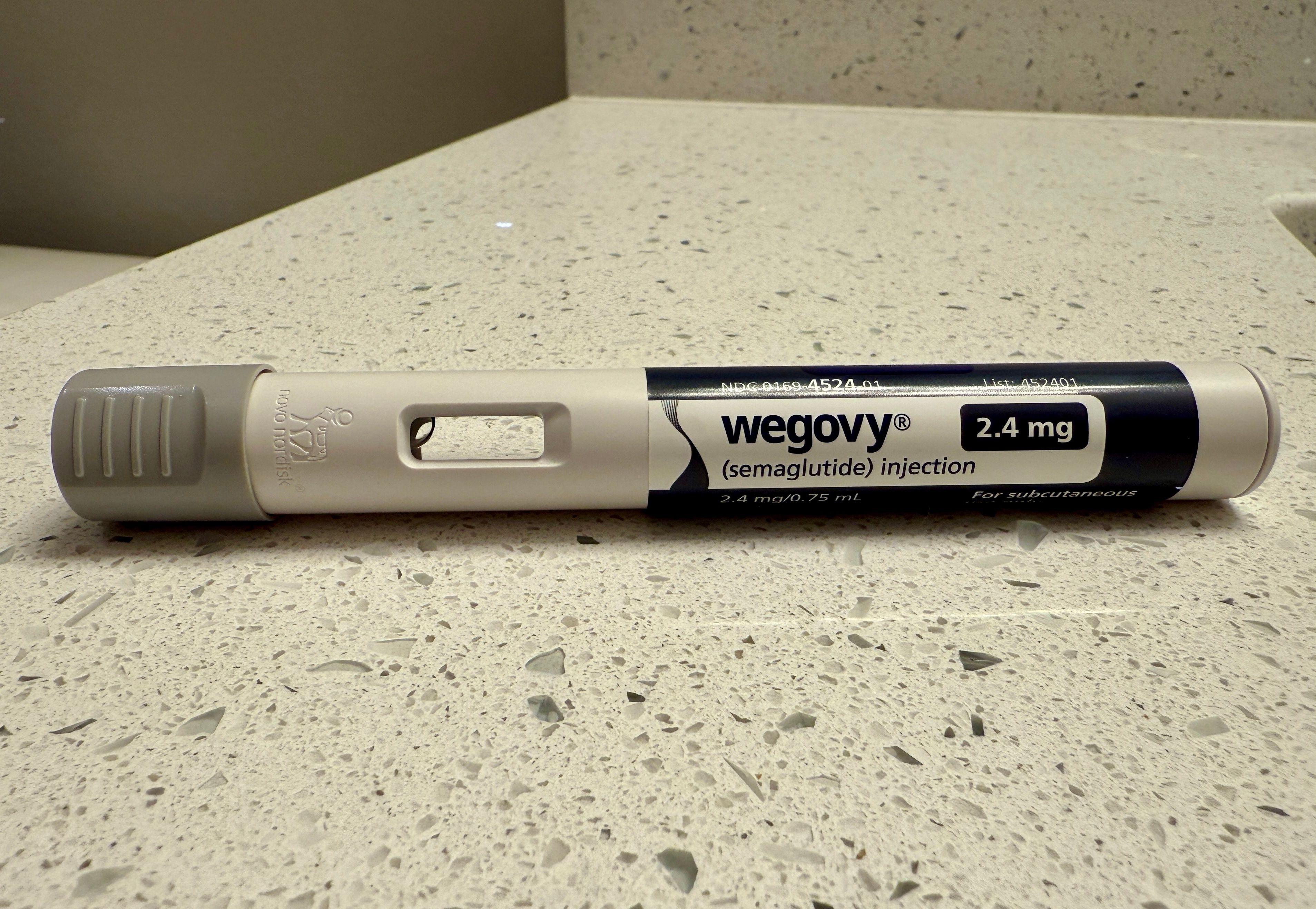 Woman Gives Wegovy Shot to Herself at Home - GLP-1 Weight Loss Prescription Medication Has Become Super Popular, Expensive, and Difficult to Obtain - Woman Giving Herself a Shot at Home - Image credit: Matt Fowler KC | stock.adobe.com