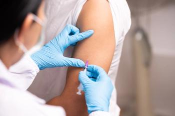Doctor hand in blue gloves holding influenza vaccine for prevention human.Nurse holding syringe make injection in shoulder of patient in hospital.Covid-19 or coronavirus vaccine - Image credit: Arcyto | stock.adobe.com
