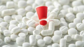 White pills with a red exclamation mark symbolize medication safety alert - Image credit: TensorSpark | stock.adobe.com