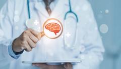 Doctor examines digital brain scan on tablet displaying neural network and medical technology | Image Credit: Your Design Master | stock.adobe.com