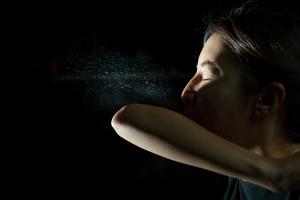 Woman coughing or sneezing in her elbow. Concept of stop spread of the virus. Spray infection - Image credit: marchsirawit | stock.adobe.com
