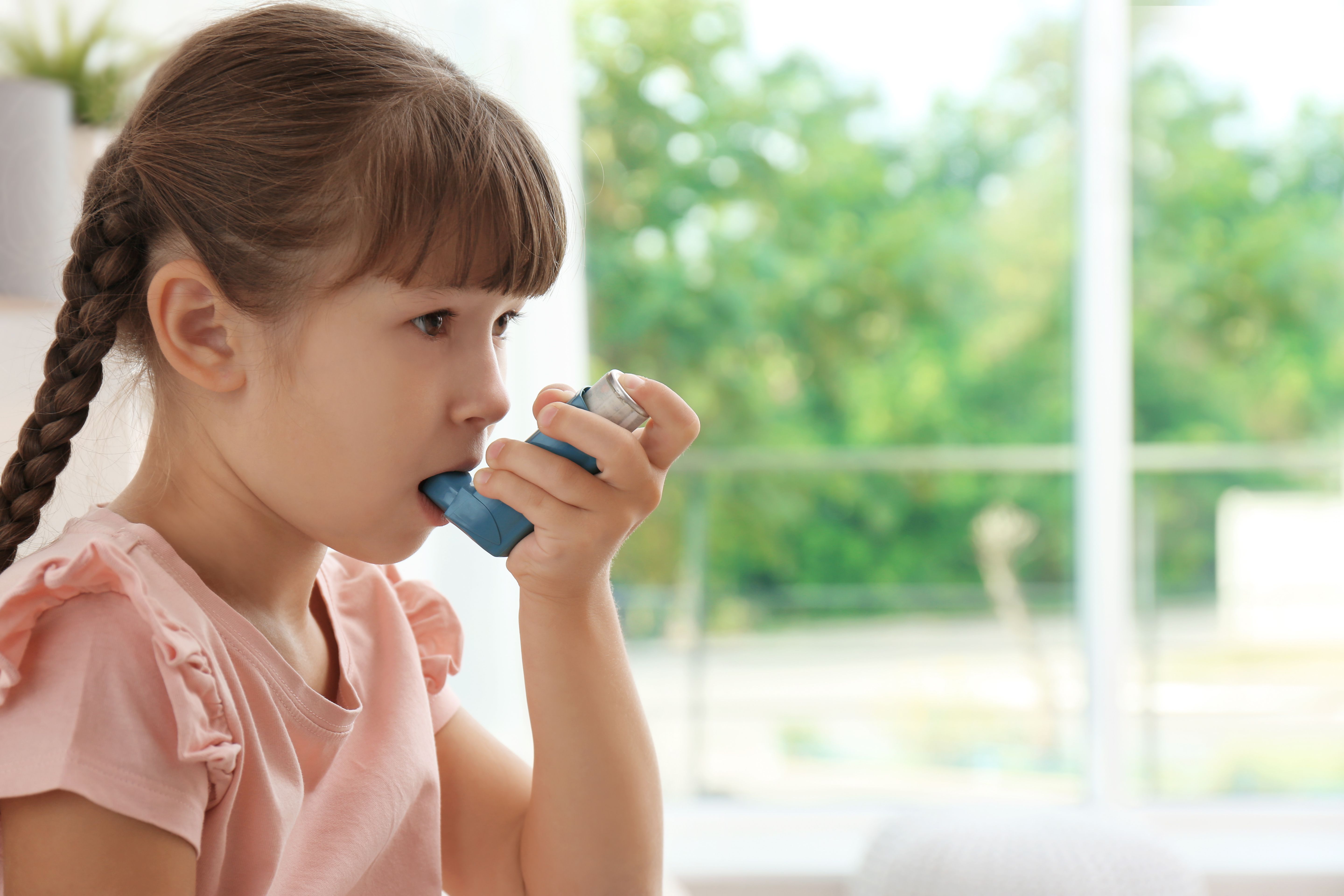 Girl with asthma using inhaler -- Image credit: New Africa | stock.adobe.com