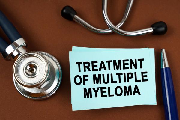 On a brown surface there is a stethoscope, a pen and blue stickers with the inscription - treatment of multiple myeloma | Image Credit: Dzmitry | adobe.stock.com
