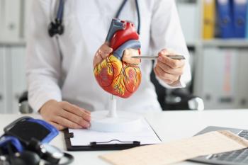 Physician pointing to a heart model