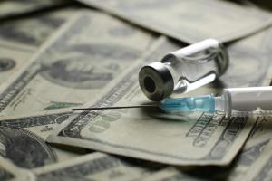 Vial with syringe vaccine and many dollars - Image credit: Qwenergy | stock.adobe.com