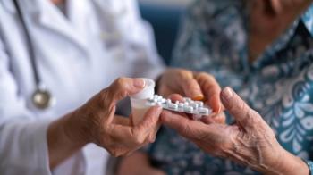 A doctor hands over a strip of pills to an older patient, ensuring proper medication management - Image credit: sommersby | stock.adobe.com