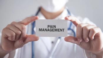 Doctor holding card. Pain Management - Image credit: andranik123 | stock.adobe.com