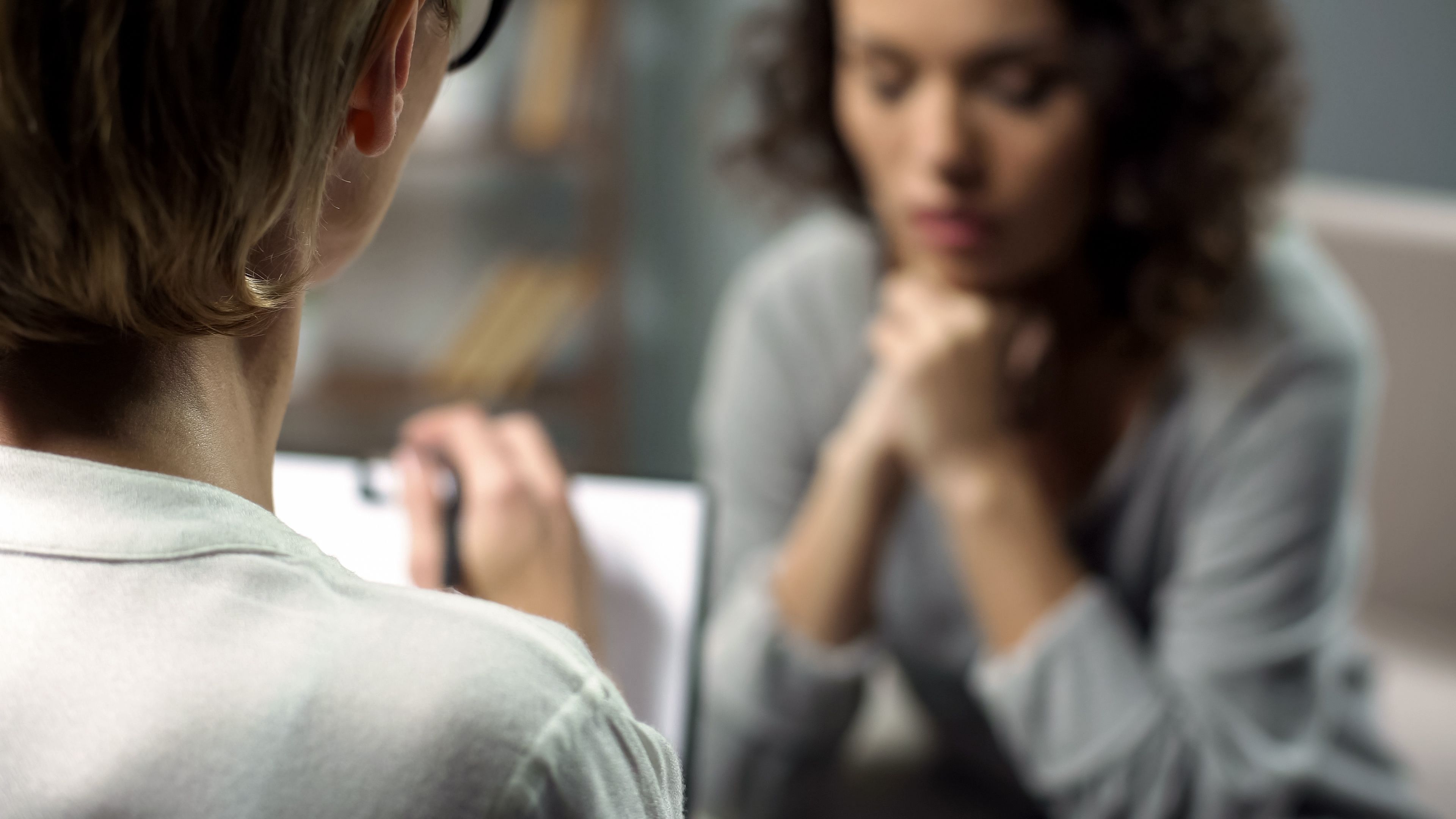 Young depressed woman talking to psychologist during session, mental health - Image credit: motortion | stock.adobe.com