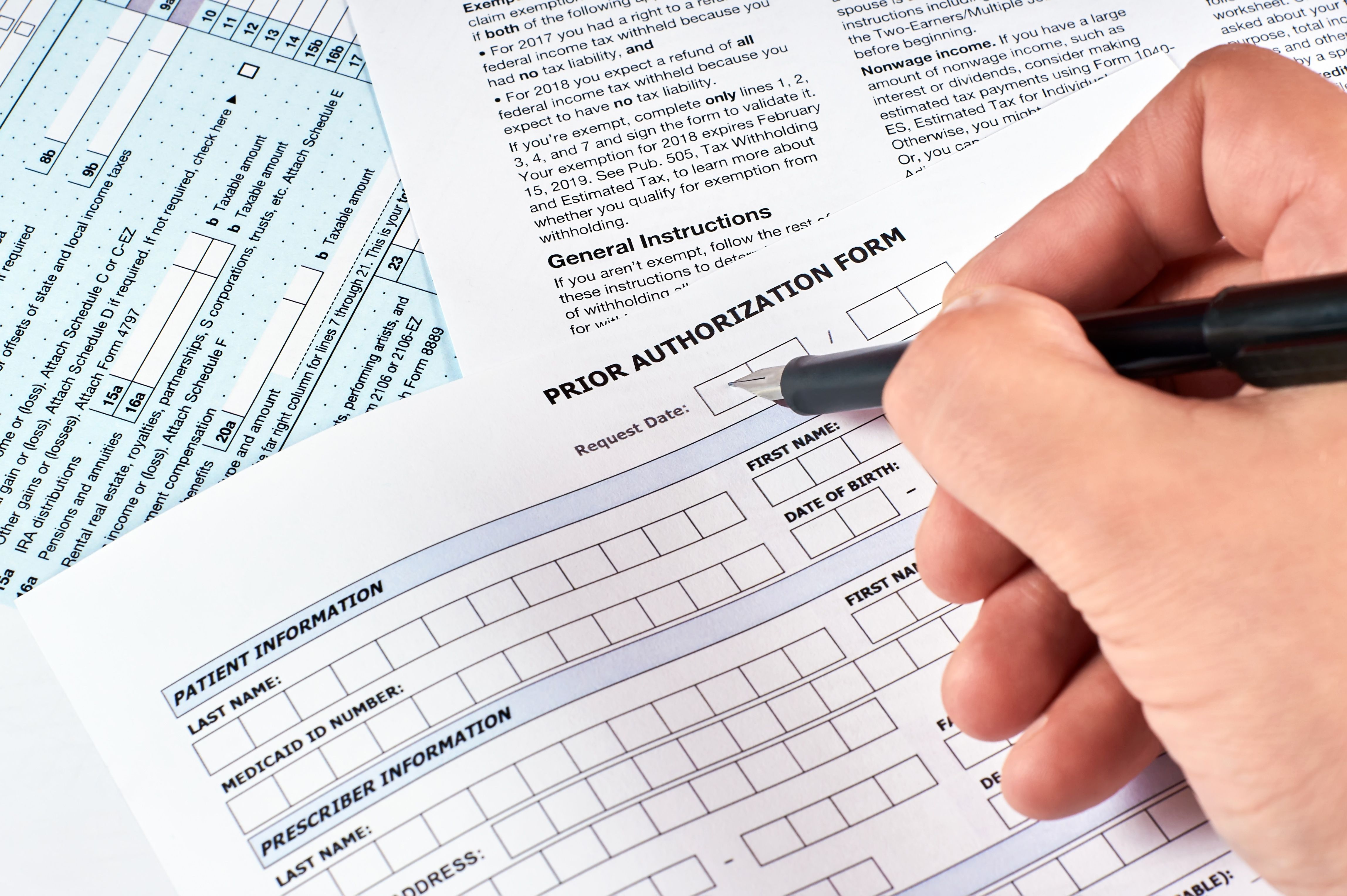 Human fills a prior authorization form - Image credit: Maksim Shchur | stock.adobe.com