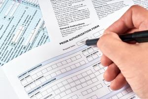 Human fills a prior authorization form - Image credit: Maksim Shchur | stock.adobe.com