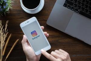 Woman using Instagram on her phone -- Image credit: Jirapong | stock.adobe.com