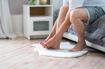 Foot pain, man suffering from feet ache in home interior - Image credit: staras | stock.adobe.com