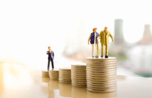 Concept of retirement planning. Miniature people: Old couple figure standing on top of coin stack - Image credit: Khongtham | stock.adobe.com