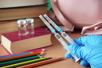 Vaccine syringes with school materials | Image Credit: © lesslemon - stock.adobe.com