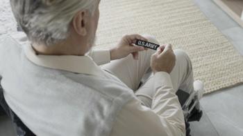 Vietnam veteran looking at US Army badge | Image Credit: © Synthex - stock.adobe.com
