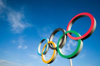 RIO DE JANEIRO - MARCH 18, 2016: A large set of Olympic rings shines in bright sunlight against blue sky. - Image credit: lazyllama | stock.adobe.com