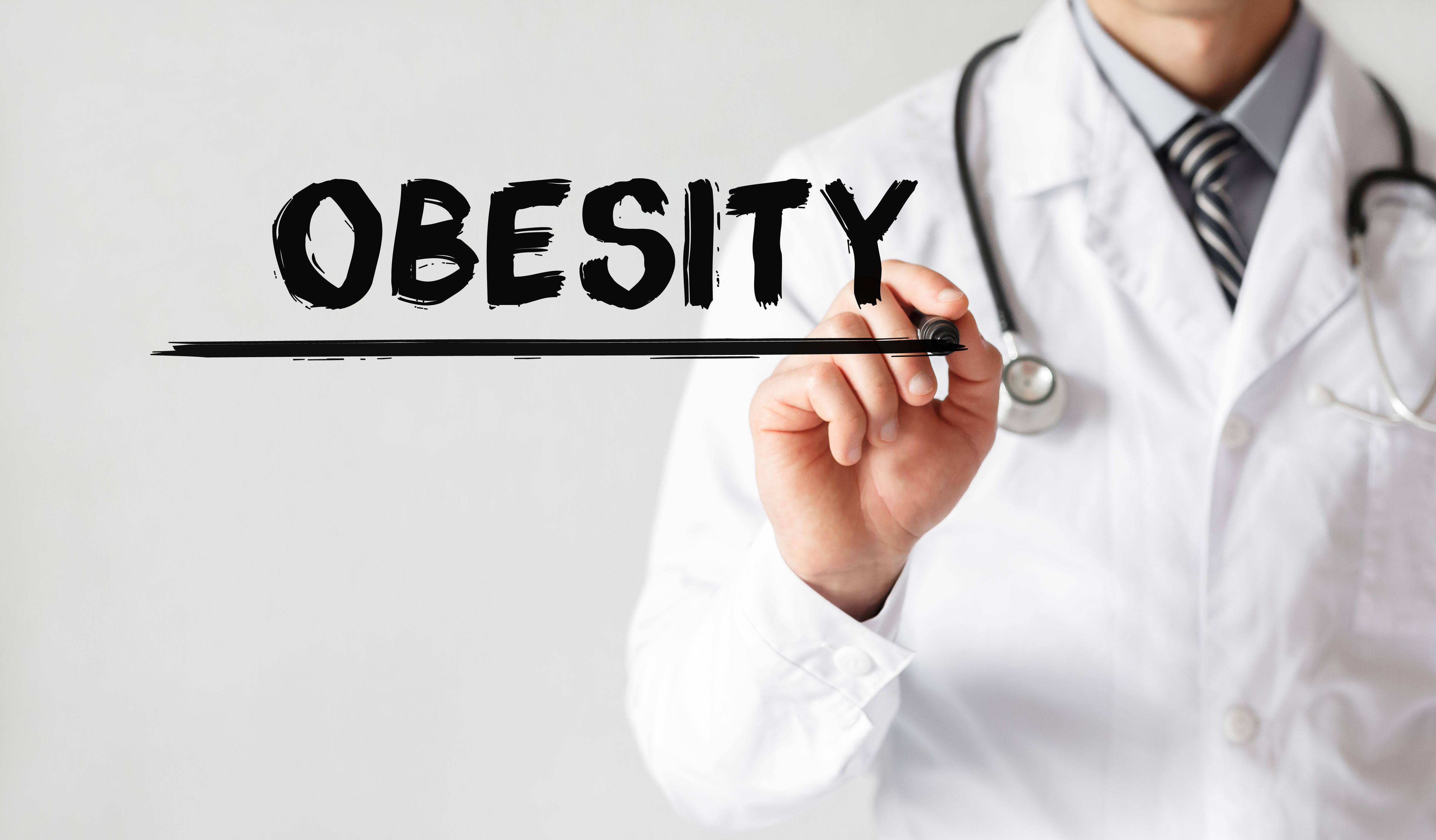 Doctor writing word OBESITY with marker, Medical concept | Image Credit: MP Studio - stock.adobe.com