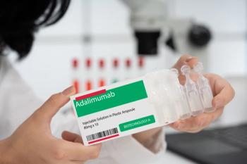 Health care professional holding adalimumab