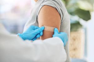 Virus vaccination, vaccine and doctor hands with plaster on patient arm in a medical hospital or clinic - Image credit: Azeemud-Deen Jacobs/peopleimages.com | stock.adobe.com