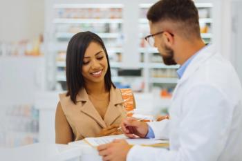 Pharmacist conversing with a patient -- Image credit: zinkevych | stock.adobe.com