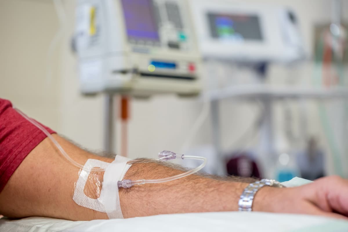 man in hospital having an intravenous drip immunoglobulin infusion