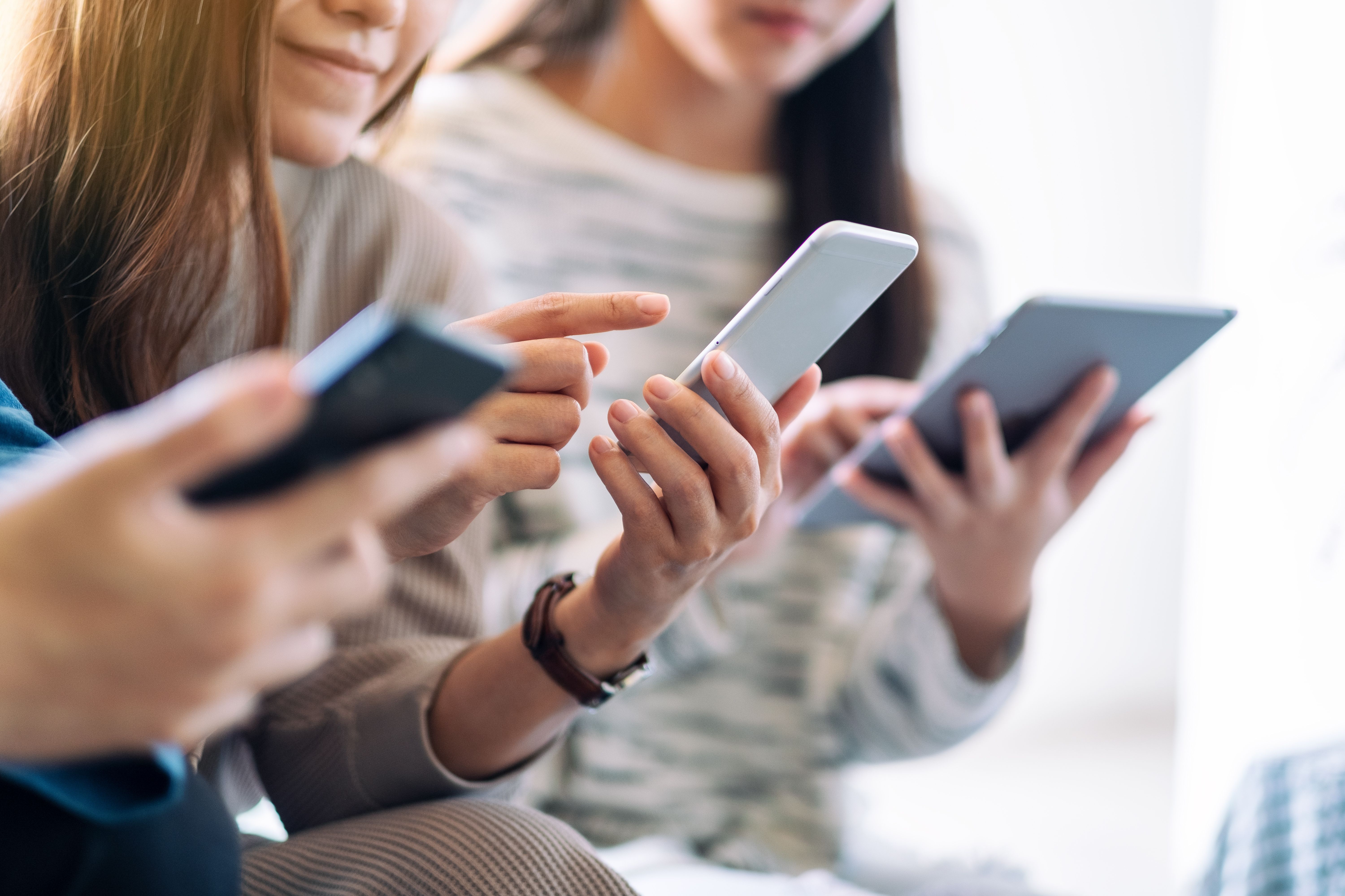 Teenagers using phones and tablets -- Image credit: Farknot Architect | stock.adobe.com