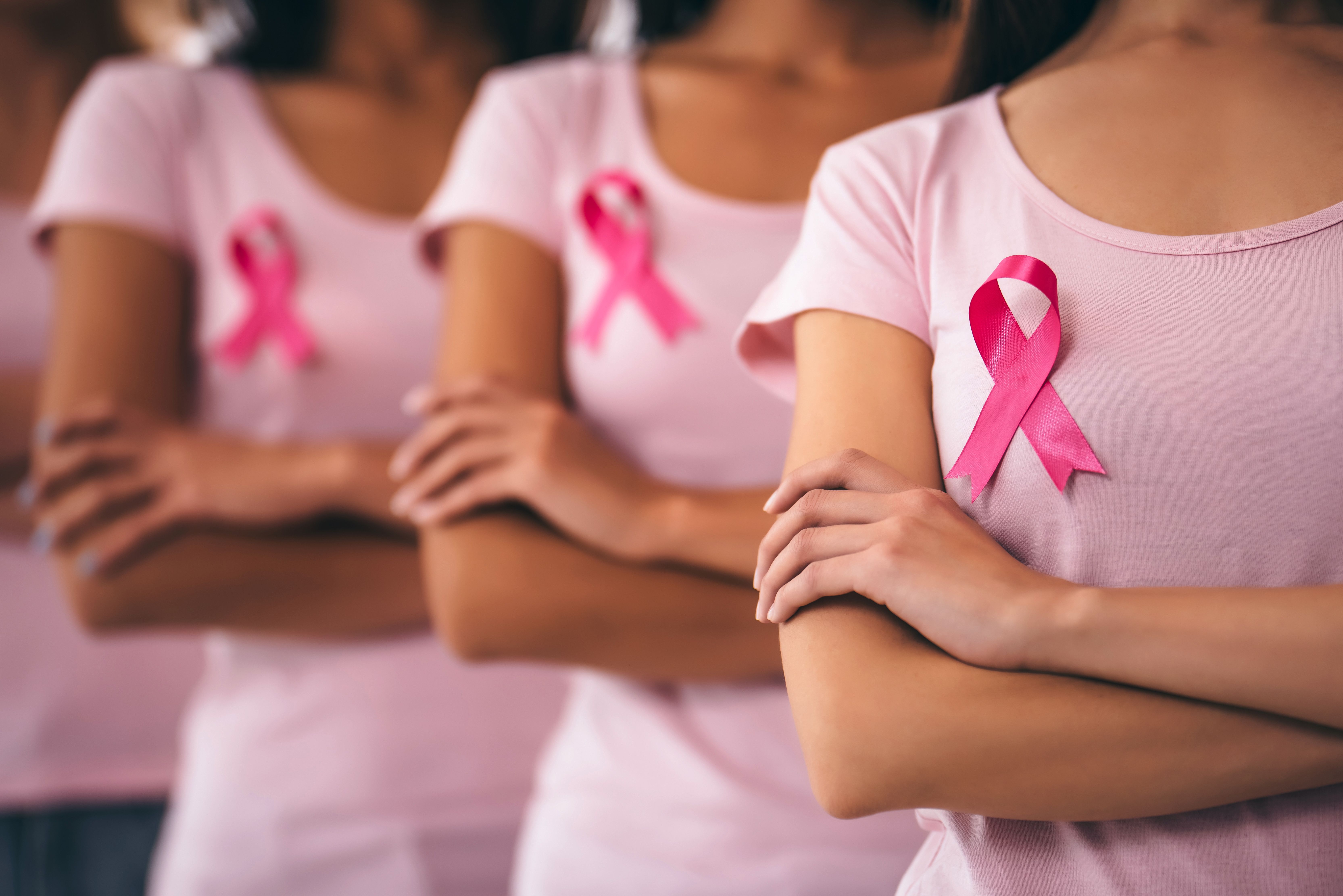 Women wearing pink ribbons for breast cancer awareness -- Image credit: Vasyl | stock.adobe.com