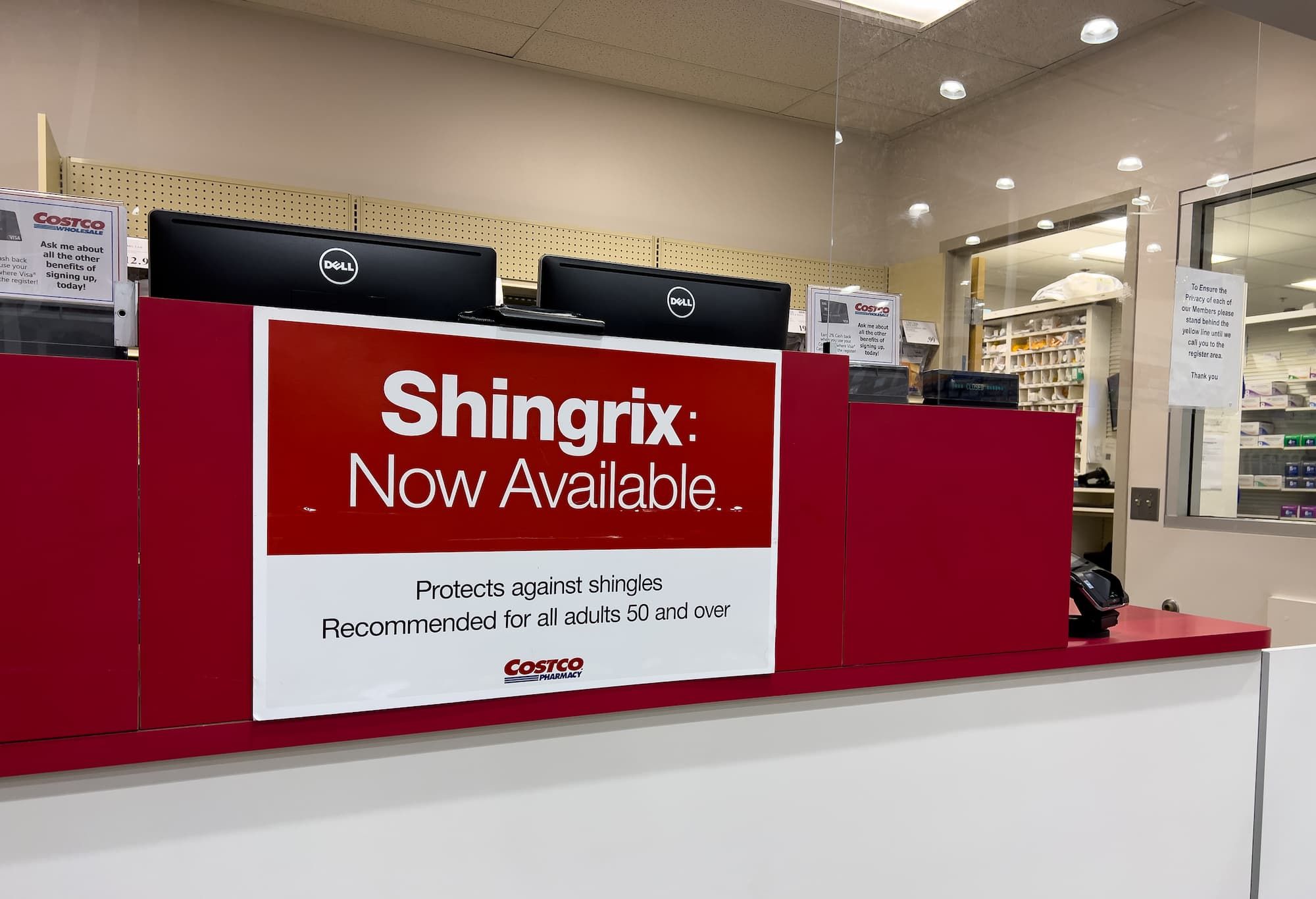 Sign indicating the availability of Shingrix brand shingles vaccine at the pharmacy counter of a local Costco store in California Sign indicating the availability of Shingrix brand shingles vaccine at the pharmacy counter of a local Costco store in California