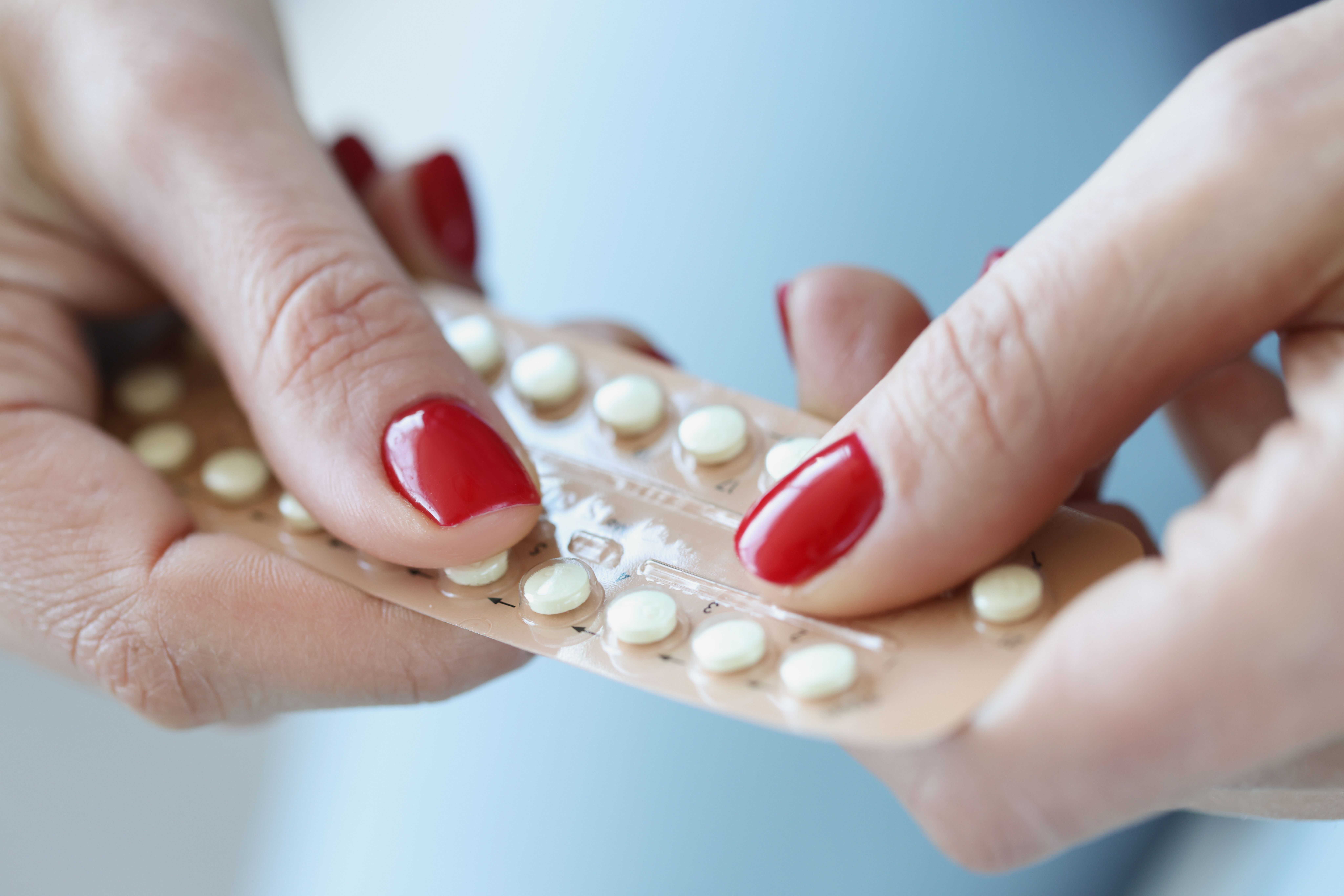 Woman with hormonal birth control pills -- Image credit: megaflopp | stock.adobe.com