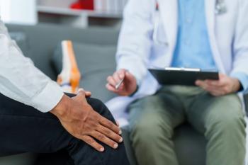 Doctor is seeing a patient. sitting and holding his knees with discomfort Meanwhile, bone model. talking about knee pain or osteoarthritis - Image credit: R Photography | stock.adobe.com