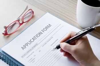 Person filling out application form -- Image credit: emiliezhang | stock.adobe.com