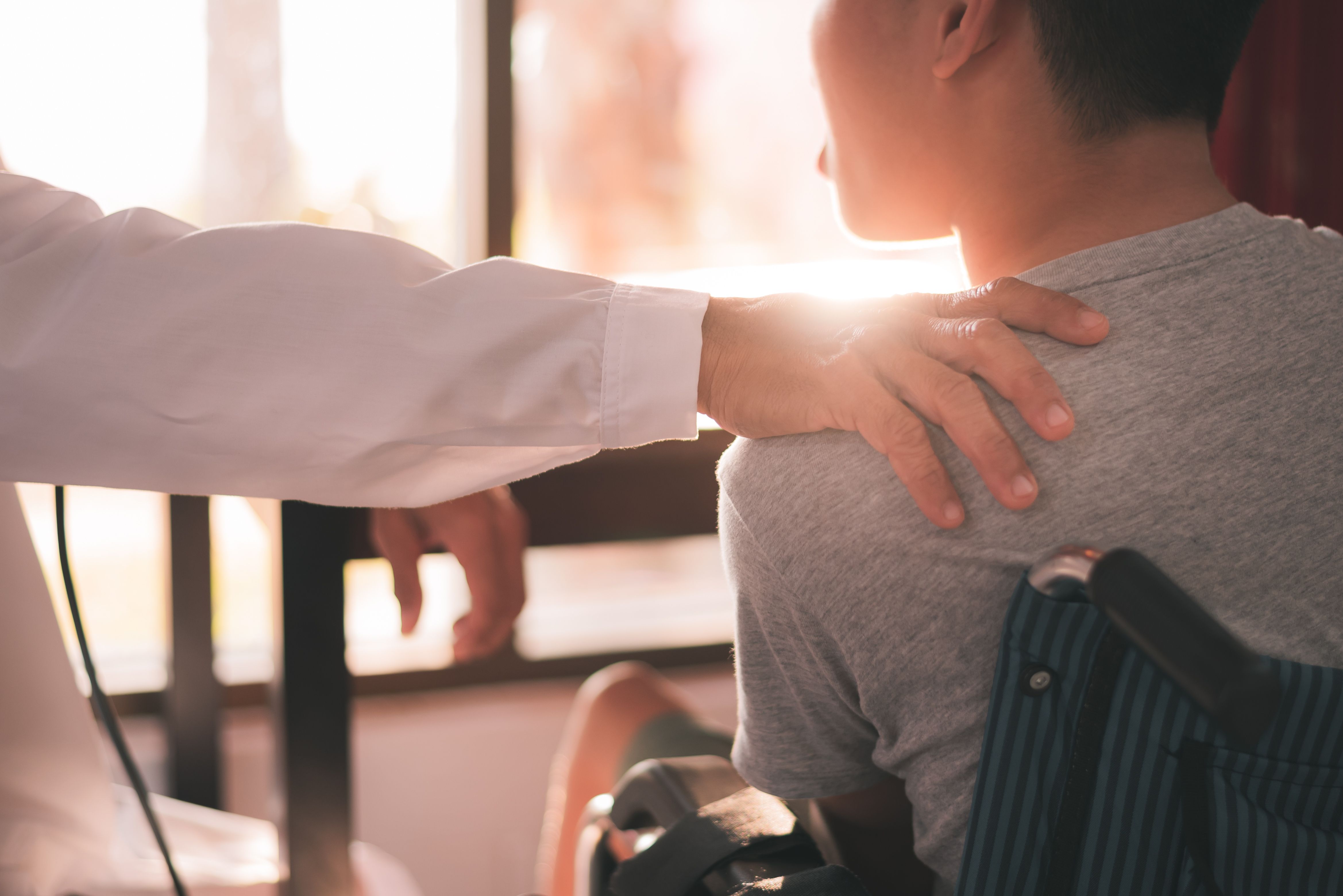 Clinician comforting patient with autism spectrum disorder | Image Credit: © GAYSORN - stock.adobe.com