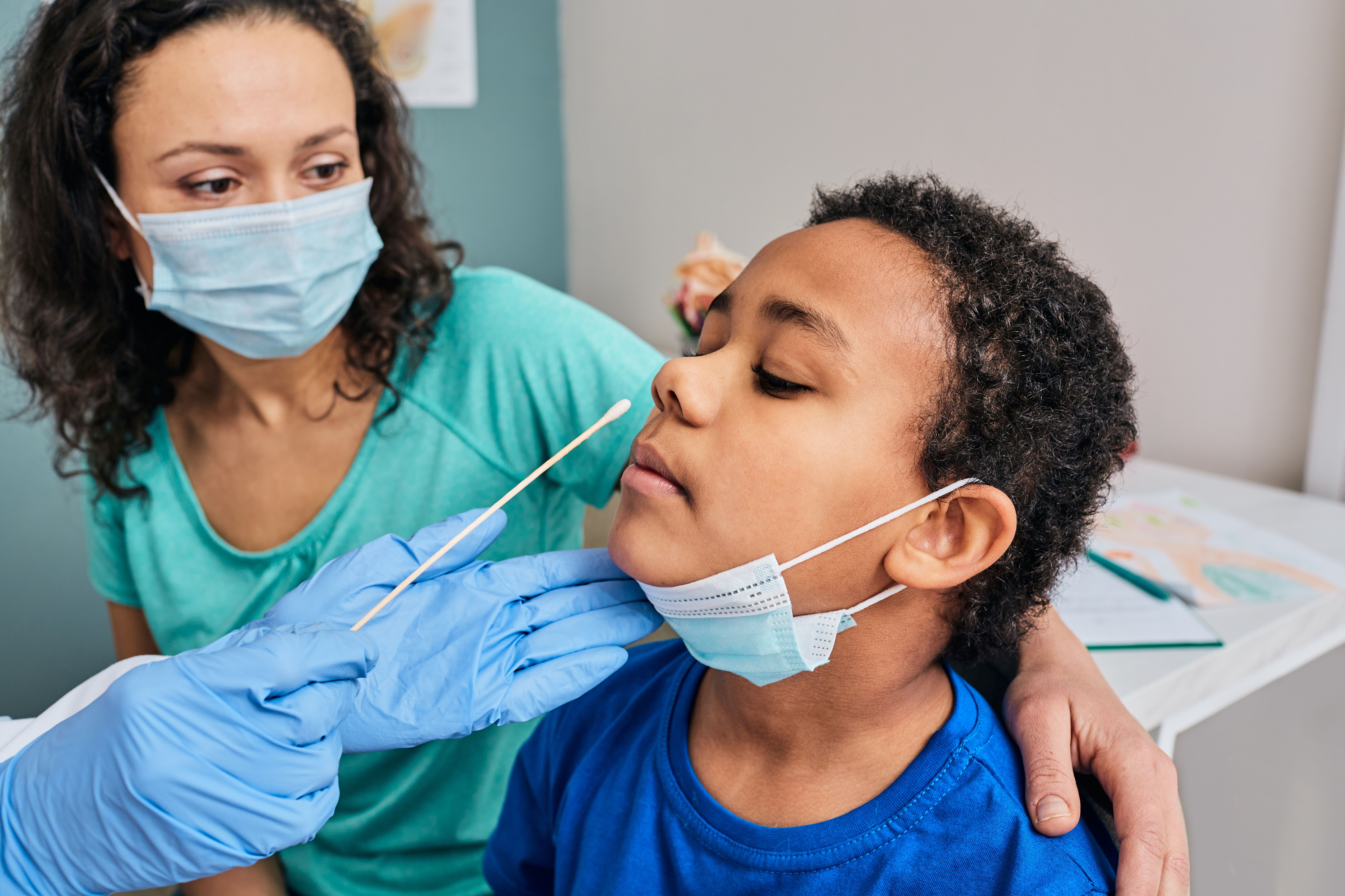 Young patient receiving nasal swab -- Image credit: Peakstock | stock.adobe.com