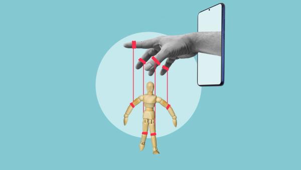 Digital Manipulation and Online Control Concept, Human Hand Controlling Wooden Puppet Through Smartphone, Social Media Addiction, Dopamine Loop and Algorithm Influence | Image Credit: © Andrii - stock.adobe.com