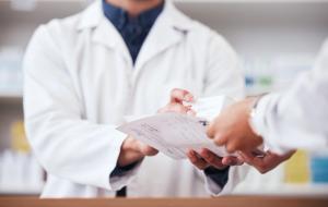 Pharmacist giving patient their prescription -- Image credit: Talia Mdlungu/peopleimages.com | stock.adobe.com