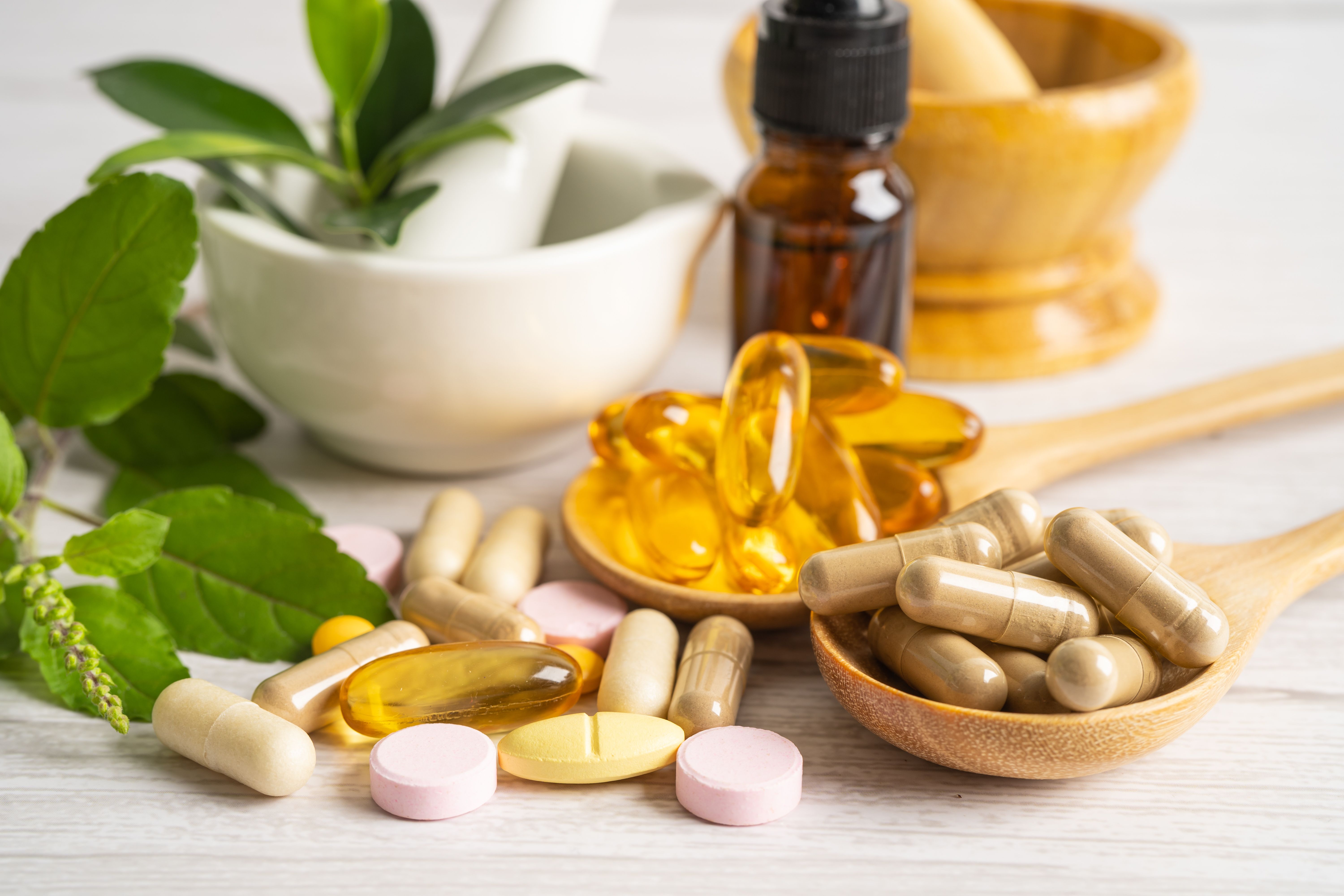 Alternative medicine herbal organic capsule with vitamin E omega 3 fish oil, mineral, drug with herbs leaf natural supplements for healthy good life - Image credit: amazing studio | stock.adobe.com