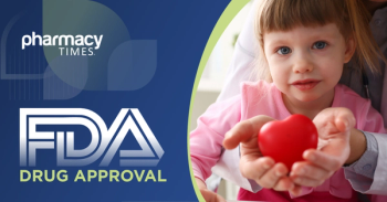 Little baby girl visiting doctor holding in hands red toy heart
