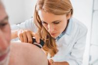 Doctor dermatologist examines skin of patient. Dermatoscopy, prevention of melanoma, skin cancer. | Image credit: InsideCreativeHouse | stock.adobe.com