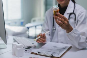Pharmacist reviewing a prescription -- Image credit: crizzystudio | stock.adobe.com