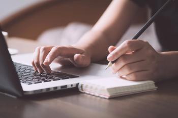 Woman typing on laptop and taking notes -- Image credit: structuresxx | stock.adobe.com
