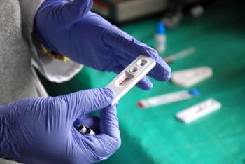Clinician holding HIV test, Africa | Image Credit: © francovolpato - stock.adobe.com