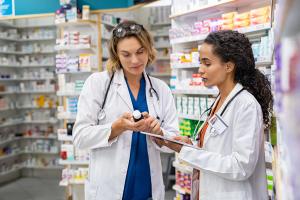 Two pharmacists in a pharmacy -- Image credit: Rido | stock.adobe.com