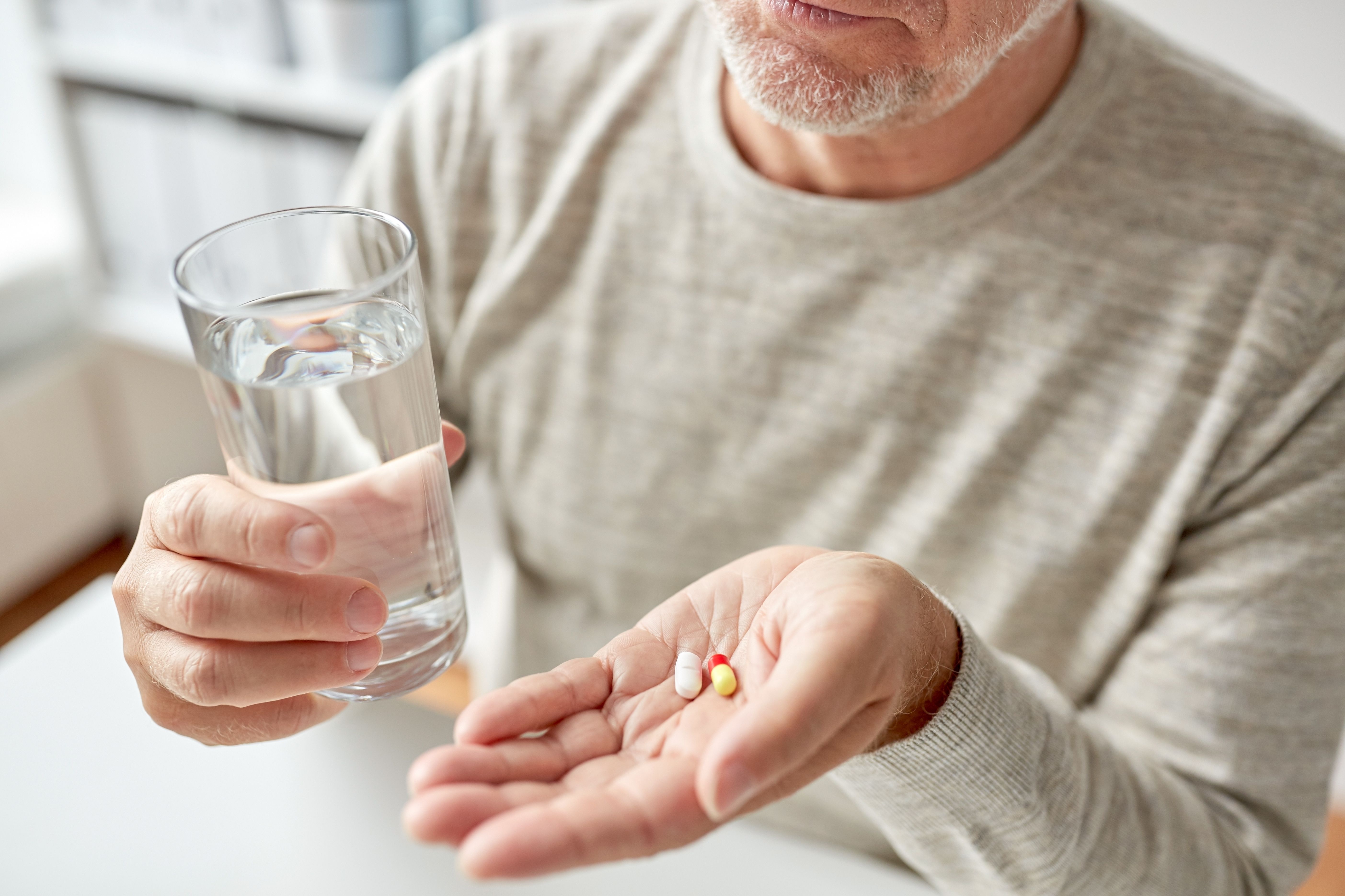 Man with Alzheimer disease taking brain supplements -- Image credit: Syda Productions | stock.adobe.com