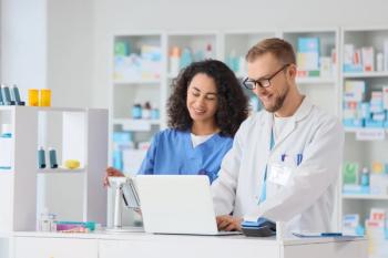 Pharmacist and pharmacy technician collaborating on laptop for prescription management and customer service, the background shows shelves filled with various medications and medical supplies  - Image credit: Pixel-Shot | stock.adobe.com
